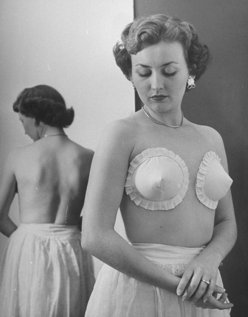 #4 A woman wearning the strapless, backless, wireless bras adhesively gummed to hold the cup on at Jones Beach.