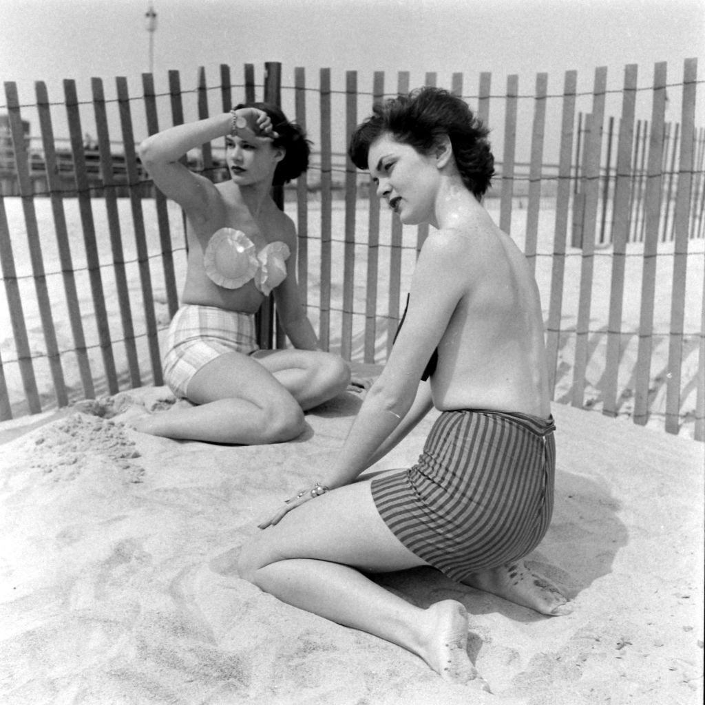 #7 Models wearing the adhesive bra on the beach, 1949.