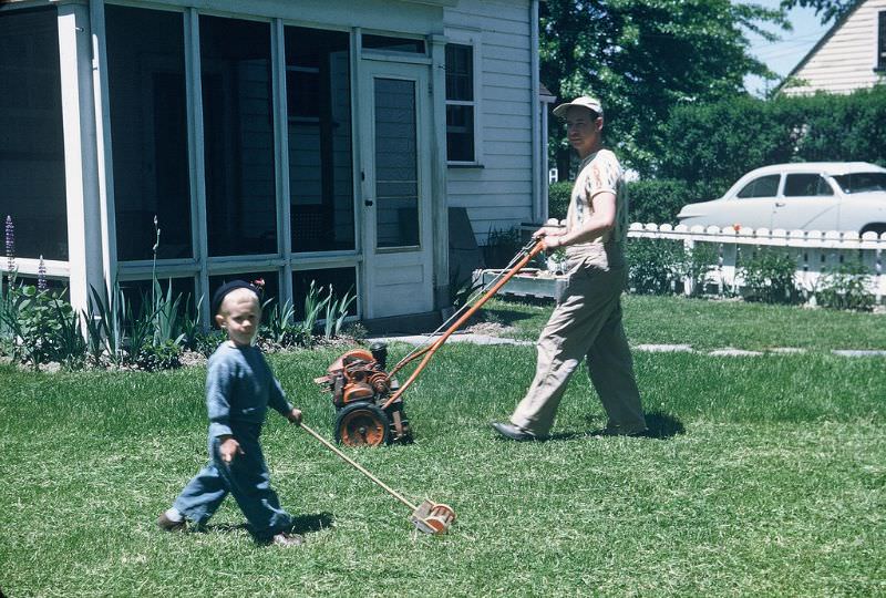 #49 Helping dad mow the lawn, Ohio. May 1951