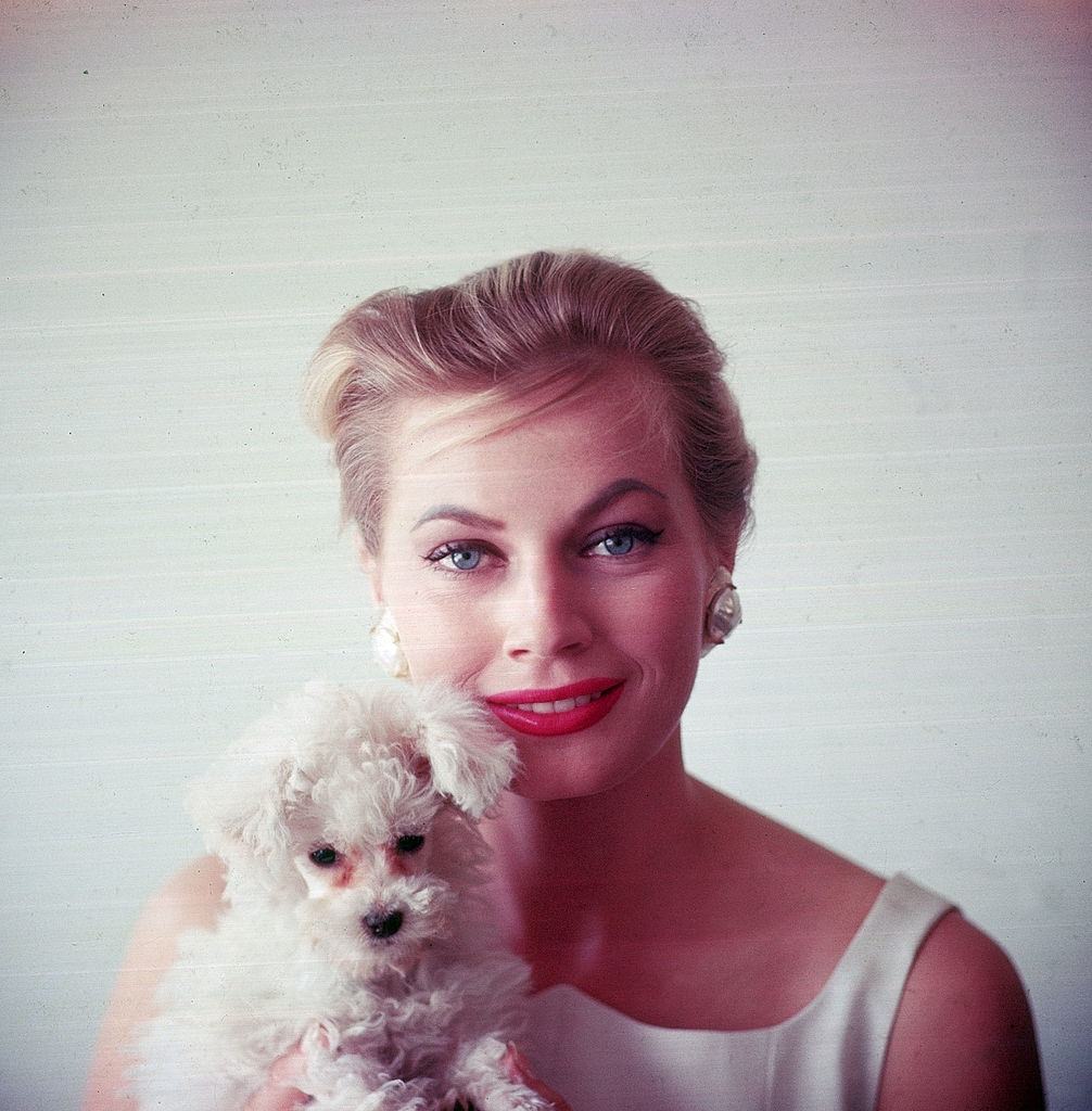 #29 Anita Ekberg holding small dog, 1955.