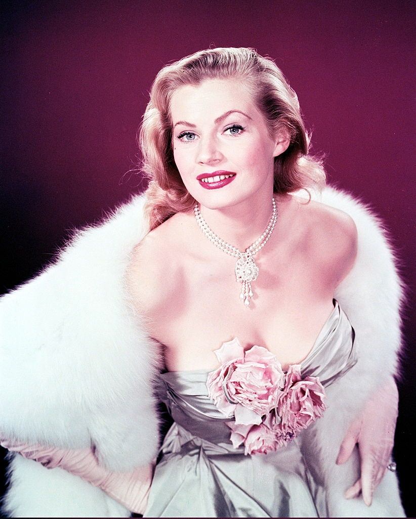 #7 Anita Ekberg wearing a glamorous in a low-cut dress, with flowers covering her cleavage, 1956.