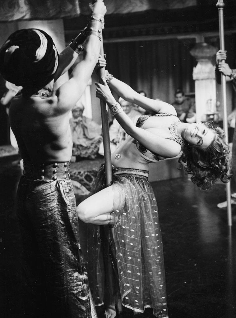 #9 Anita Ekberg dancing on a pole during a scene from the movie ‘Zarak’.