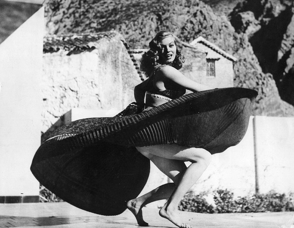 #49 Anita Ekberg dancing barefoot on the terrace of the Parador Hotel, Spanish Morocco.