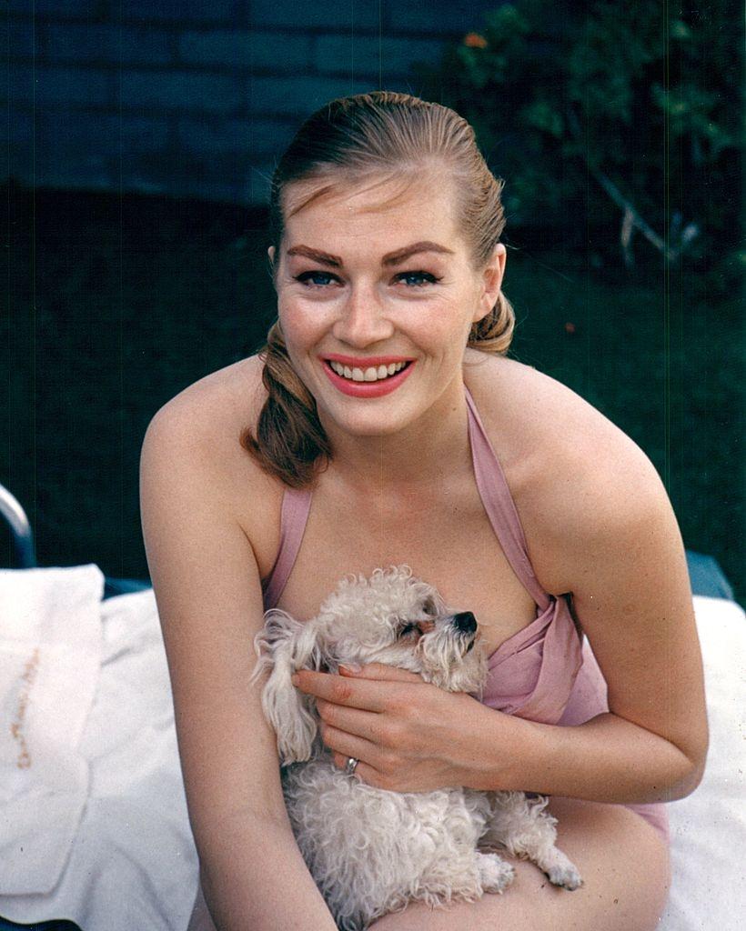 #13 Anita Ekberg posing with a dog, 1969.