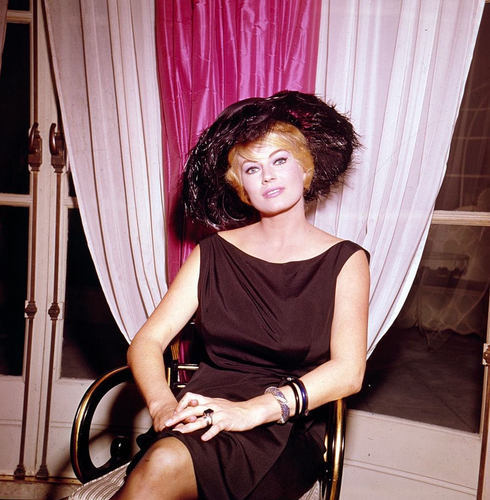 #70 Anita Ekberg posed sitting on a chair in London in 1963.