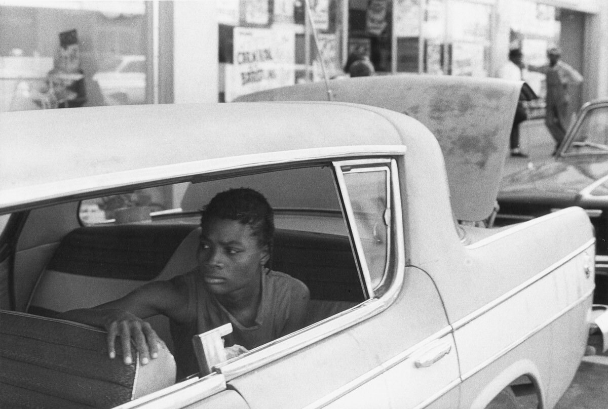 #8 Woman in back seat of car on Water Street, 1965