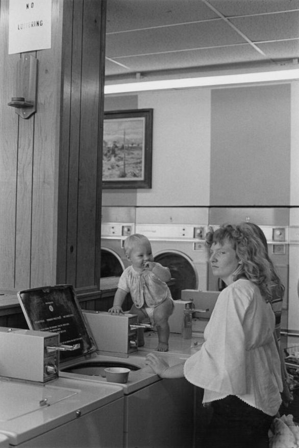 #21 Woman and baby in laundromat in Bainbridge Mall, 1973