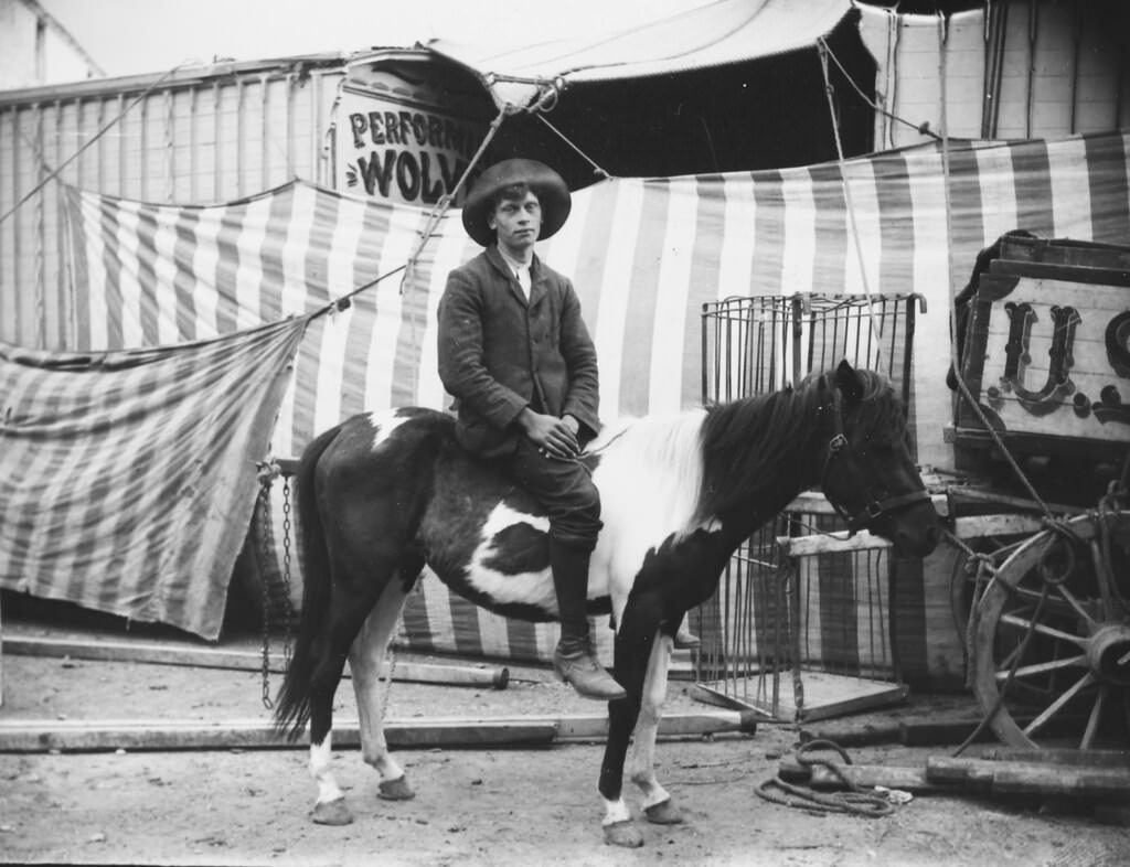 #18 Man on a horse outside a circus, 1910.