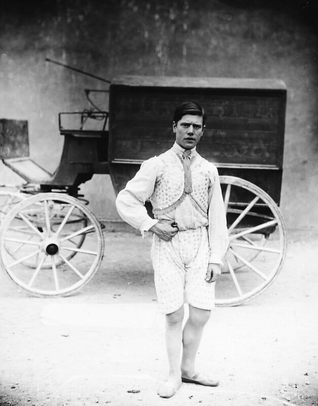 #23 A circus performer in front of a wagon, 1910.
