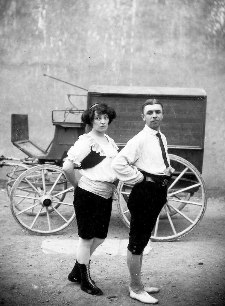 #24 Two circus performers in front of a wagon , 1910.