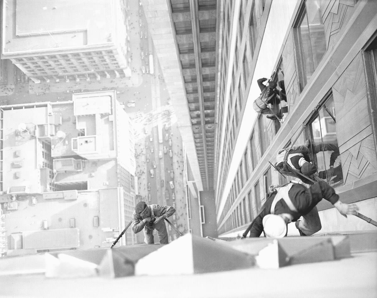 #5 The startling ‘shot’ was made by the photographer looking down upon the window washers on the 34th street side of the world-famed building.