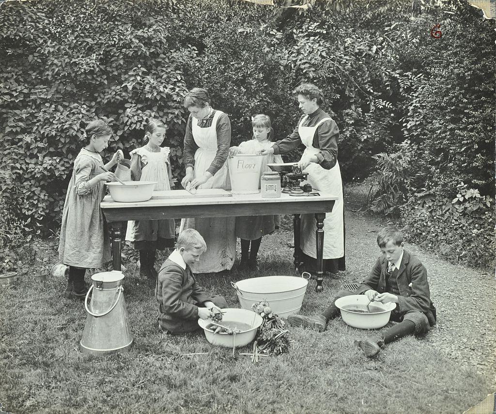 #24 Boys and girls preparing food outdoors, Birley House Open Air School, Forest Hill, London, 1908.