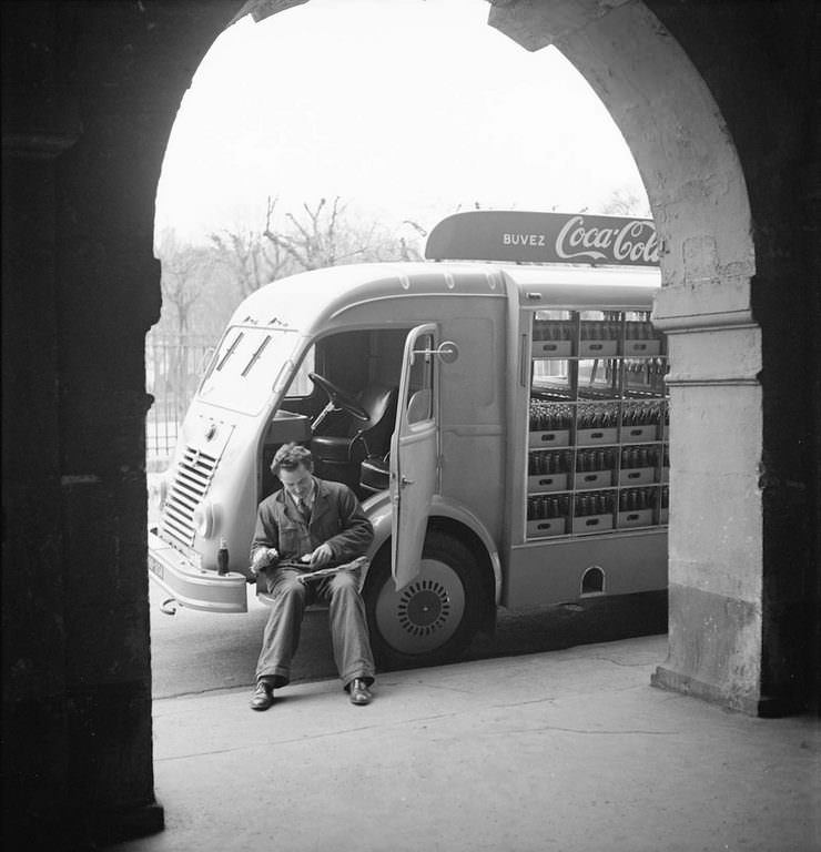 #6 A Coca-Cola delivery driver sits in the open door of his truck while on a break, in France.