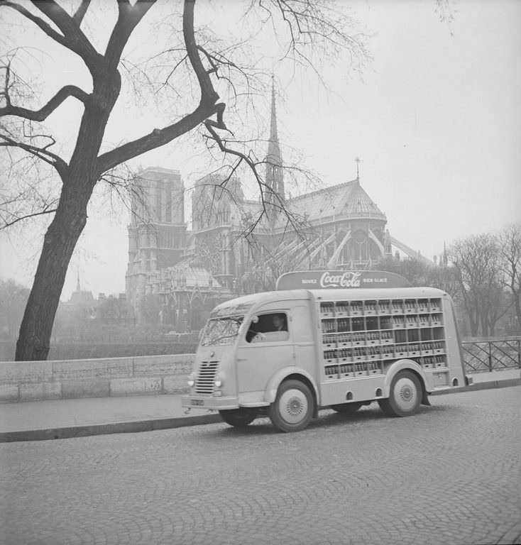 #7 View of a Coca-Cola delivery truck as it crosses Pont de l’Archeveche, near the cathedral Notre Dame de Paris.