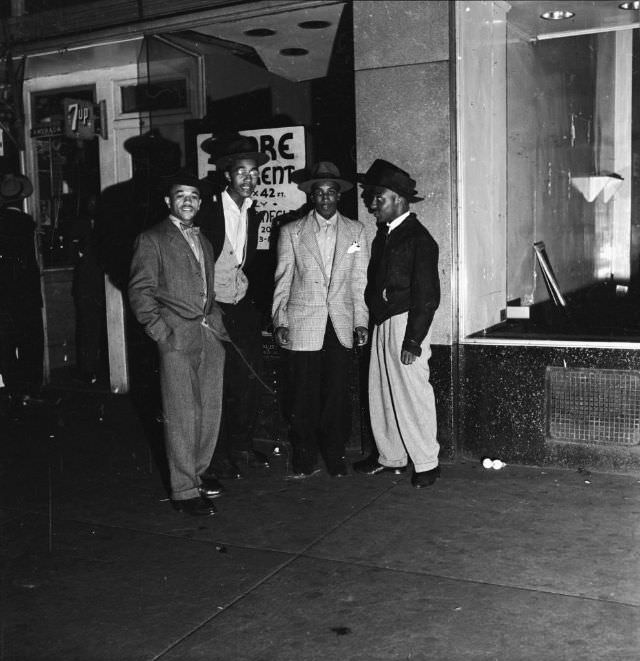 #1 A group of affluent men standing on the street at night, 1942.