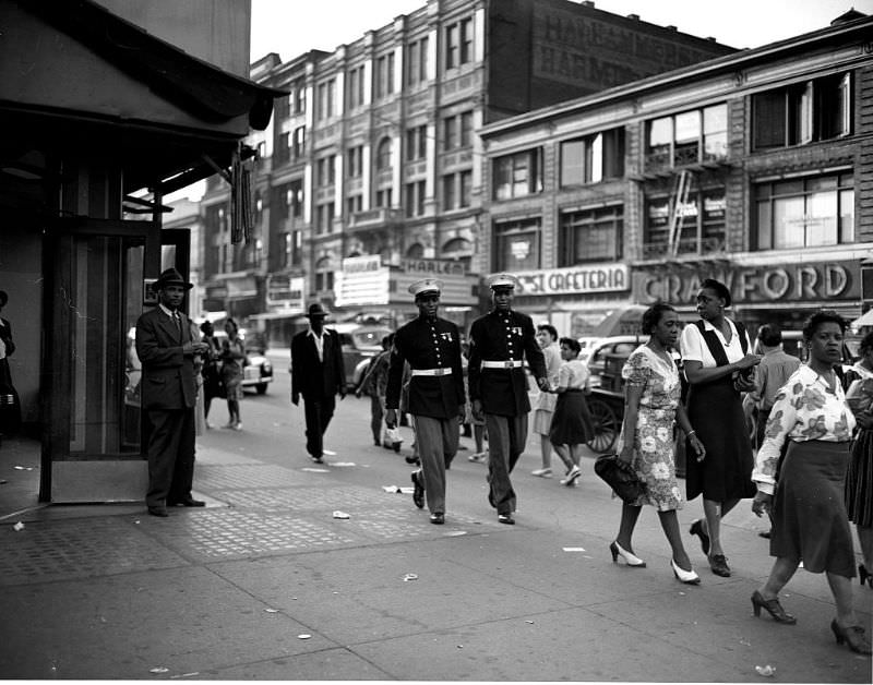 #21 Two Marines walk down a street, 1943.