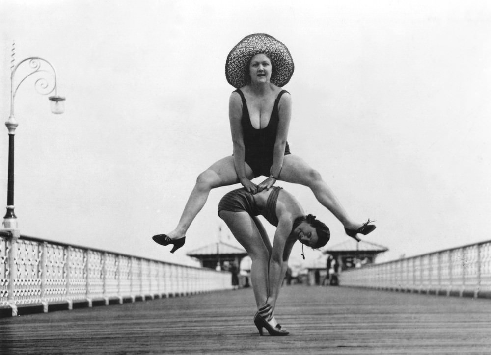 #9 Holidaymakers enjoying a game of leap-frog on the pier at Llandudno. 16th August 1935.