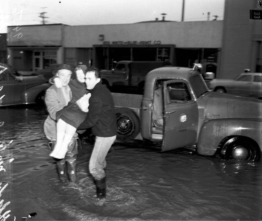 #4 Legionnaires helping old woman to truck, 18 January 1952.