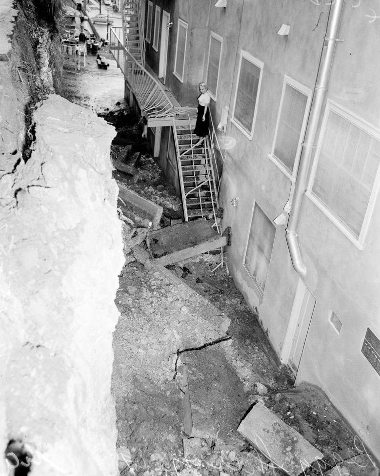 #34 A woman looking towards a landslid near her house. November 1952.
