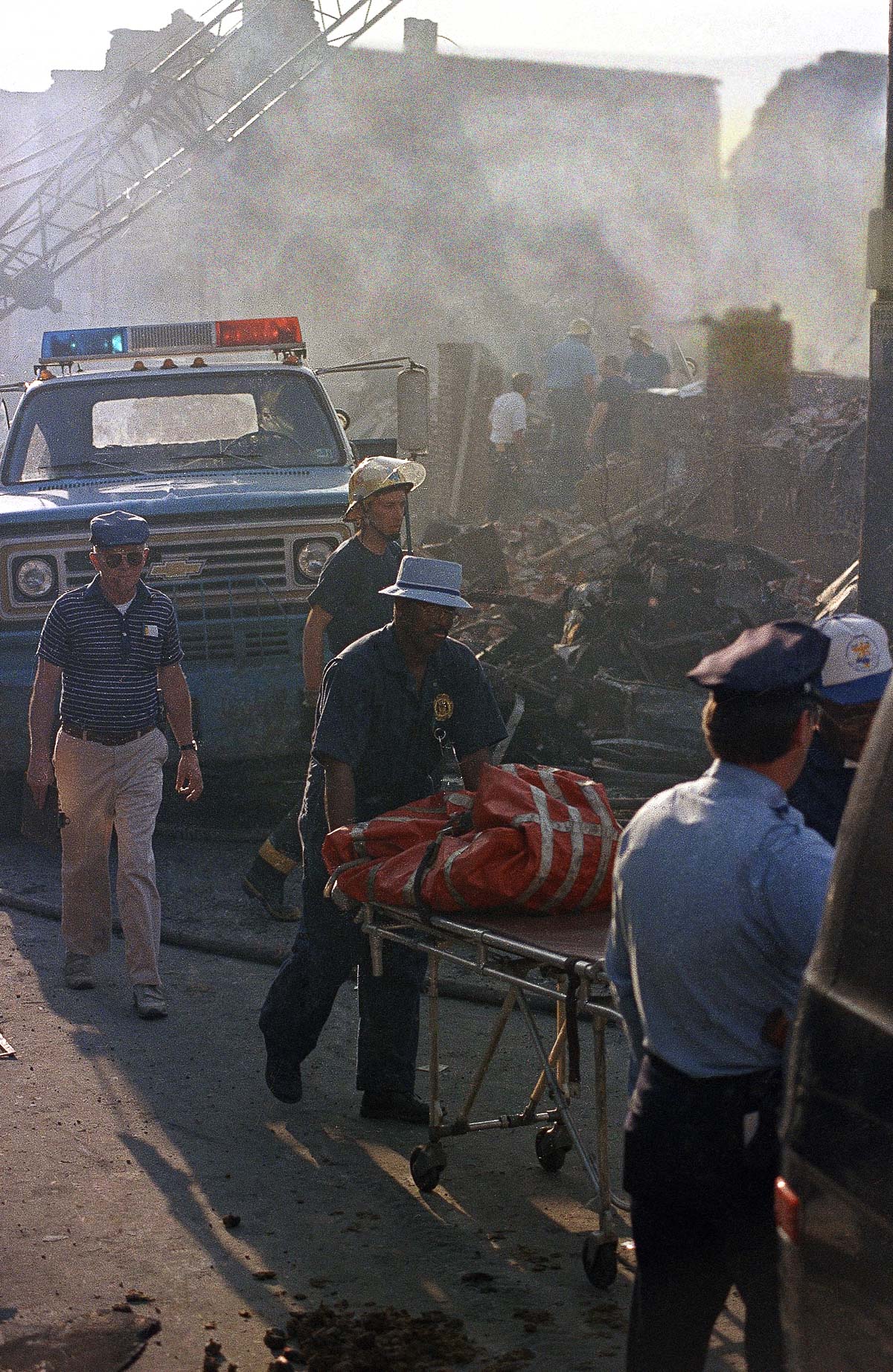 #14 Workers remove the remains of a body from the rubble. May 14, 1985