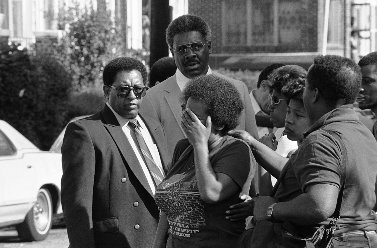 #19 A woman mourns after returning to her destroyed neighborhood. May 15, 1985