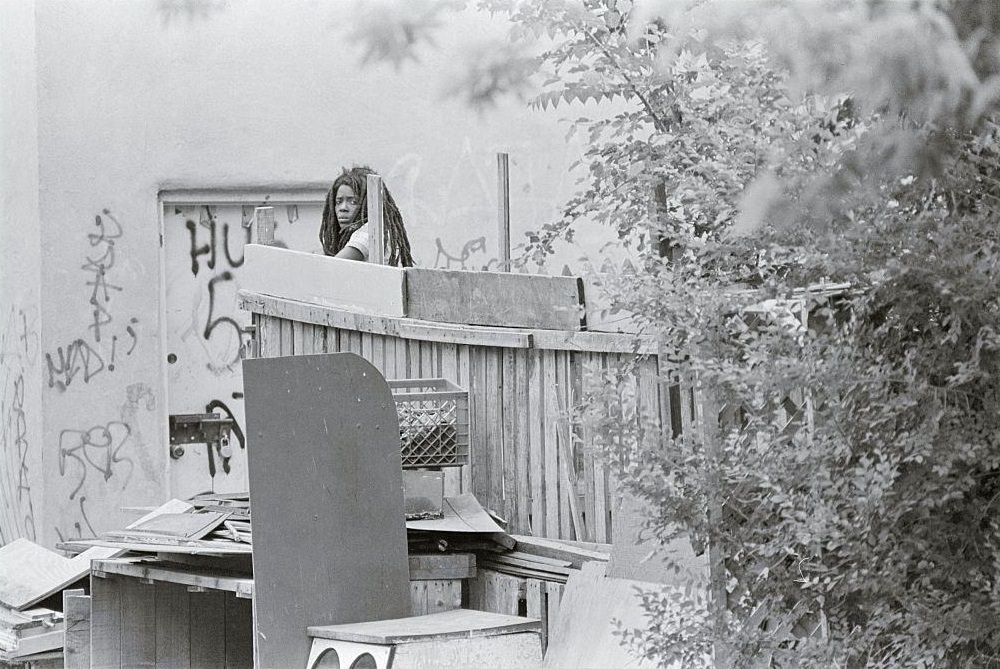 #3 A unidentified woman living in what Philadelphia police call another MOVE house as police, newsmen and sightseers walk by by homes in the southwest section of Philadelphia.