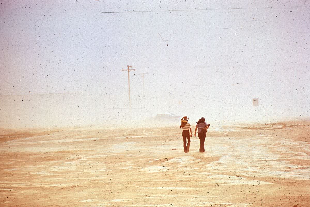 #12 Men walk through a dust storm in Shiprock, New Mexico.