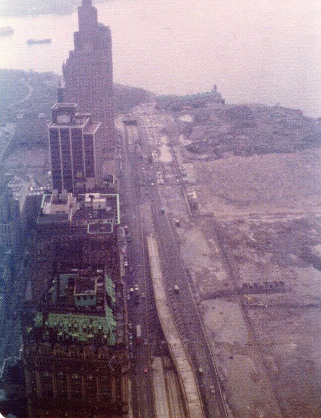 #8 View from the 58th floor of the World Trade Center to the Battery Park City landfill, Pier A, end of the West Side Highway and New York Harbor on a foggy afternoon, March 1975