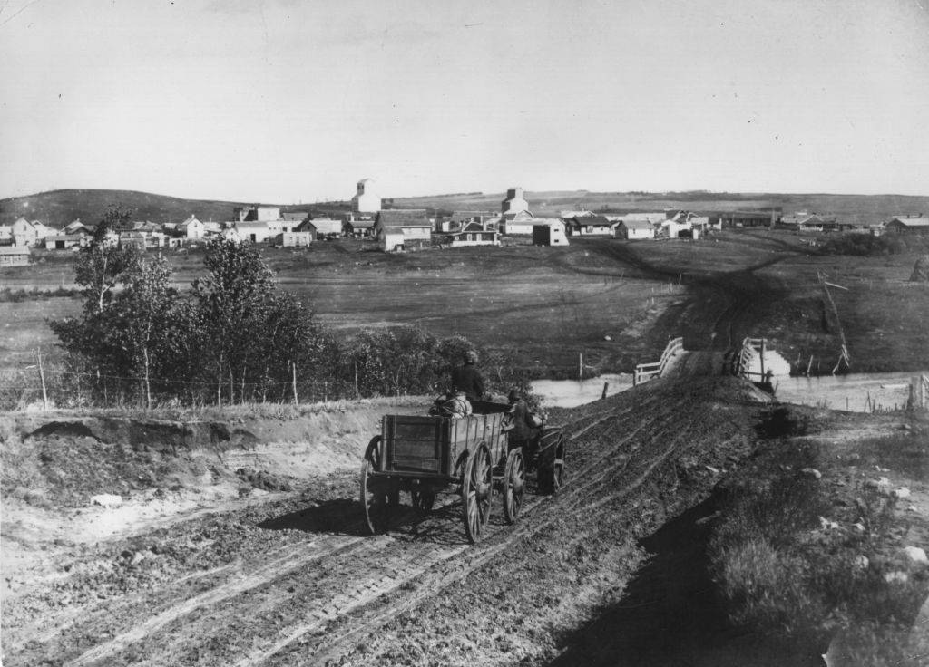 #2 A cart drives down the road to Turtleford, Saskatchewan. January 1910.