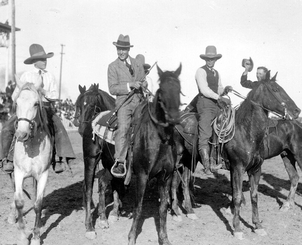 #8 The Duke of Windsor, (second from left), as Edward, Prince of Wales, riding with cowboys at Saskatoon during a royal tour. October 1919.
