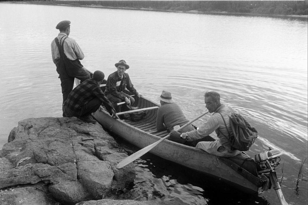 #41 People riding a boat during their search for uranium in Saskatchewan, 1930s.