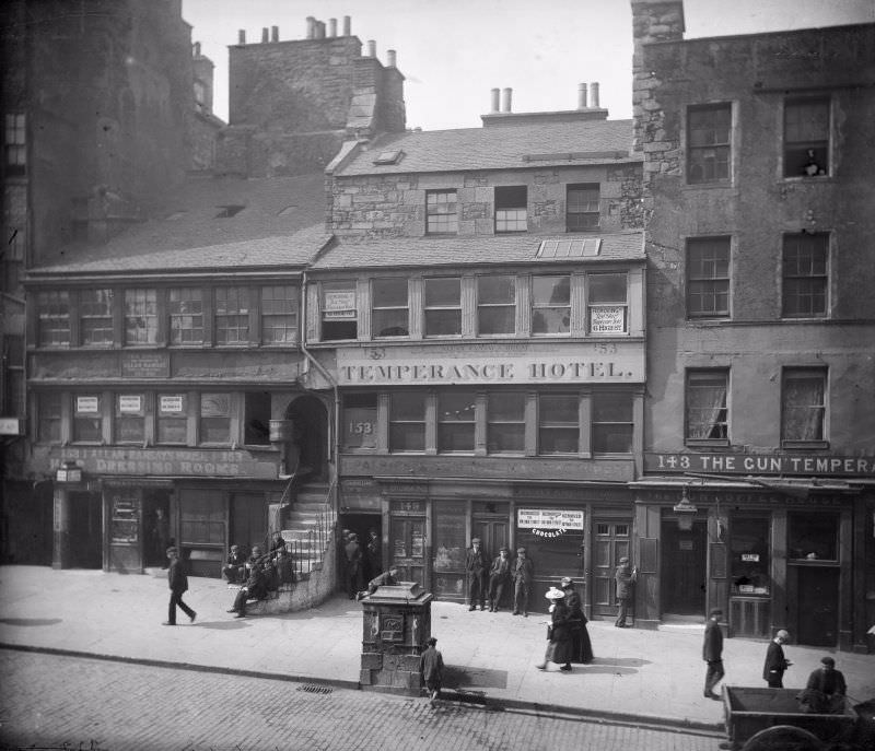 #28 High Street between Canongate and North Bridge, Edinburgh showing no 153 Allan Ramsay’s House, The Temperance Hotel, no 143 The Gun’Temperance and The Gun Coffee House, c. 1900.