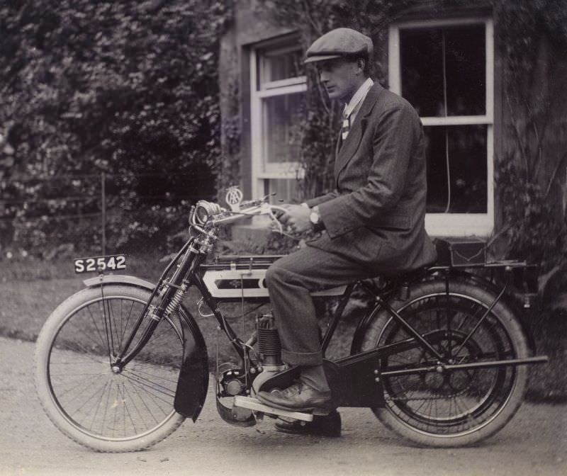 #55 Man on motorcycle, 1909.