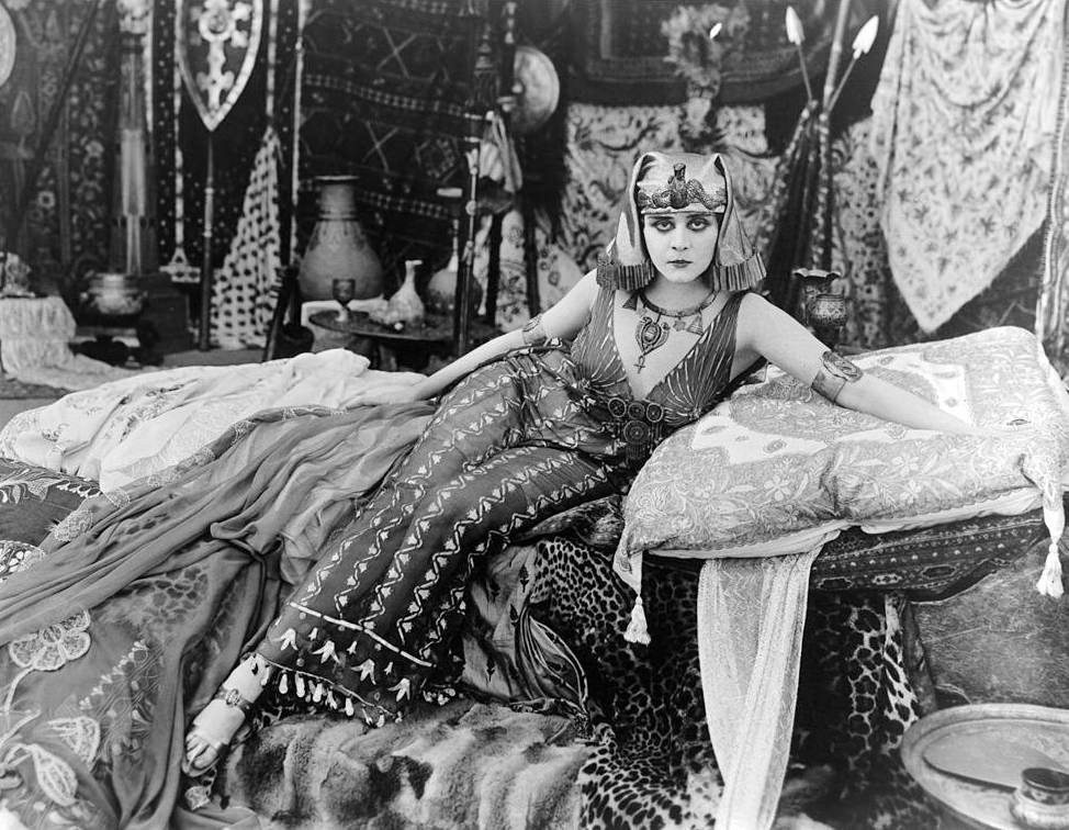 #14 Theda Bara sits on a bed of cushions in a scene from the film ‘Cleopatra’, 1917.