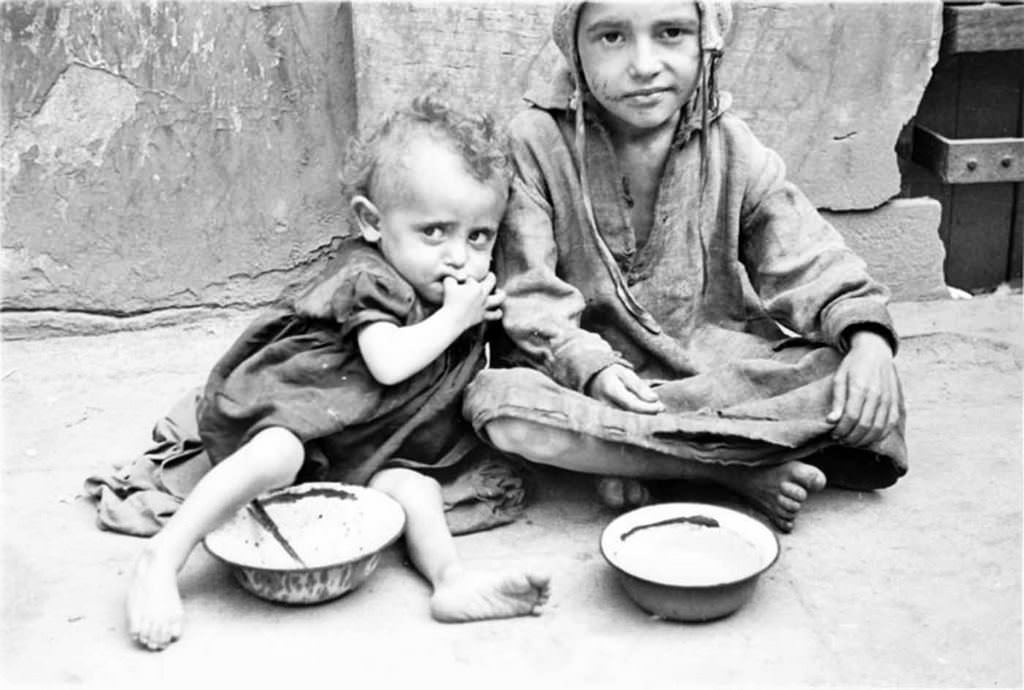 #17 Two children begging for food on the street.
