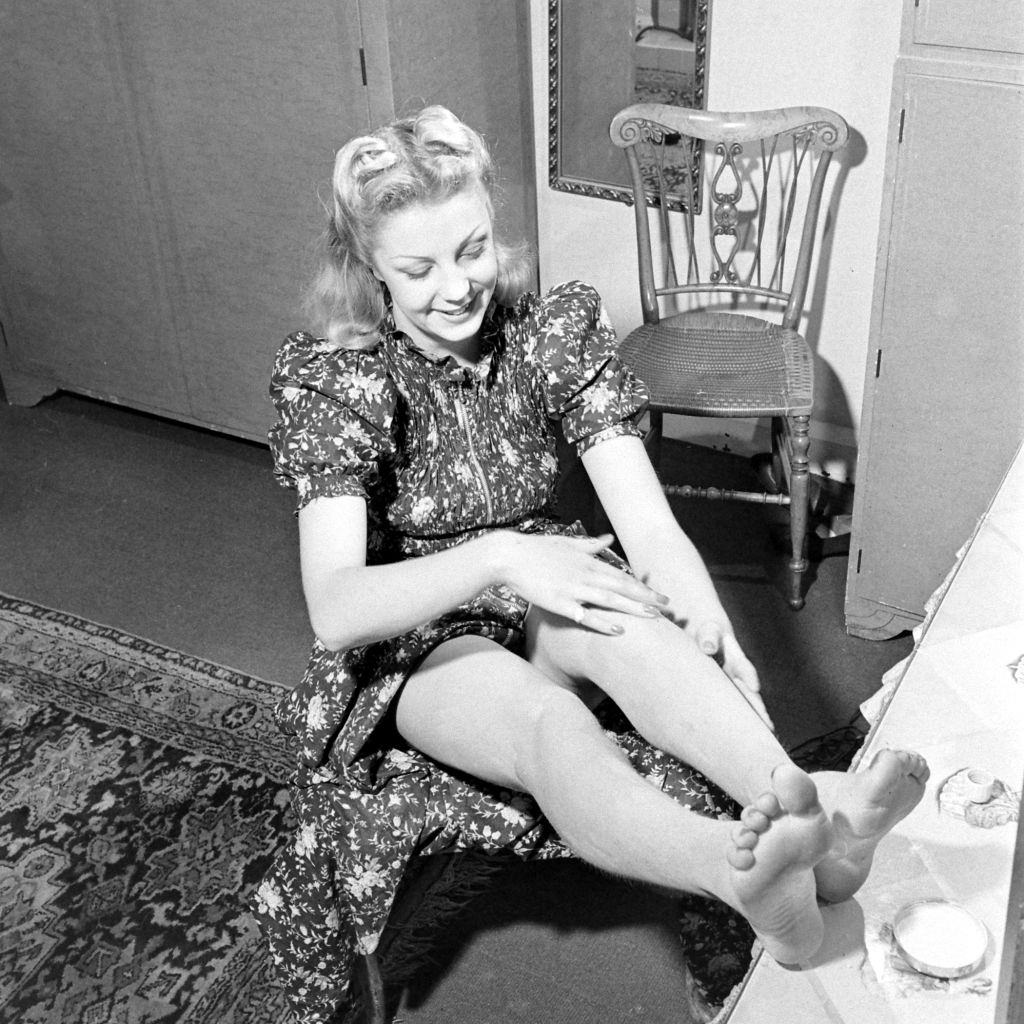 #11 Another woman applying liquid stockings during World War II, 1941.