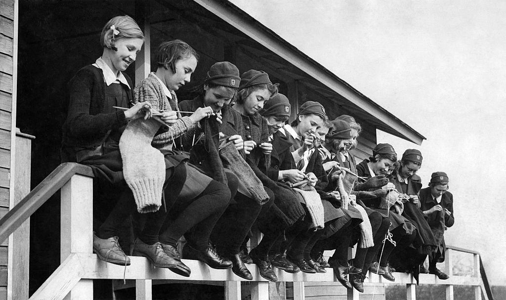 #16 Girls at the Finnermore wood camp huts are here seen knitting sea stockings and jerseys for the crews of wartime convoys. May 1941.