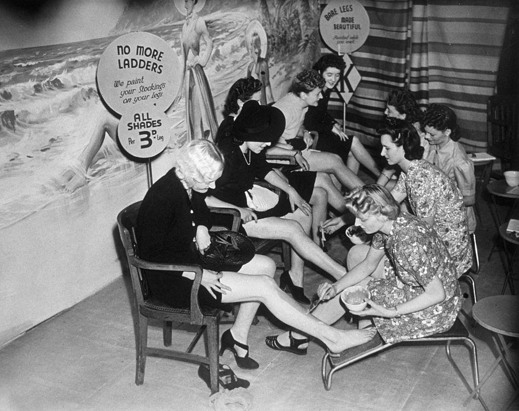 #18 Customers have their legs painted at a store in Croydon, so they can save their coupons which would otherwise be used for stockings.