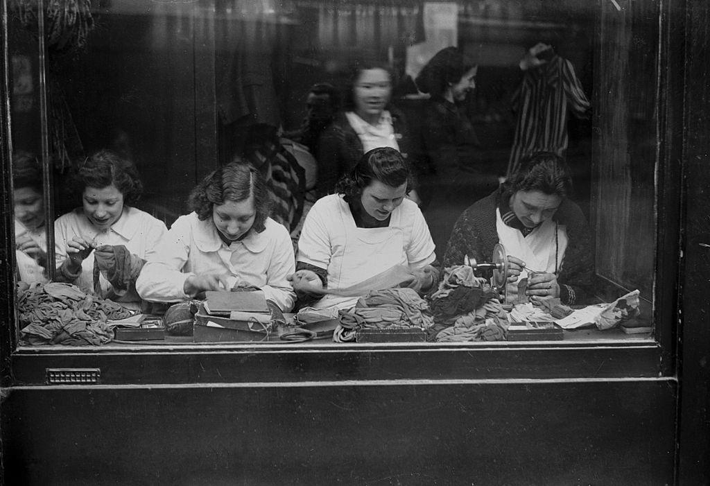 #4 Shop of mending of mesh stockings in Paris during WWII.