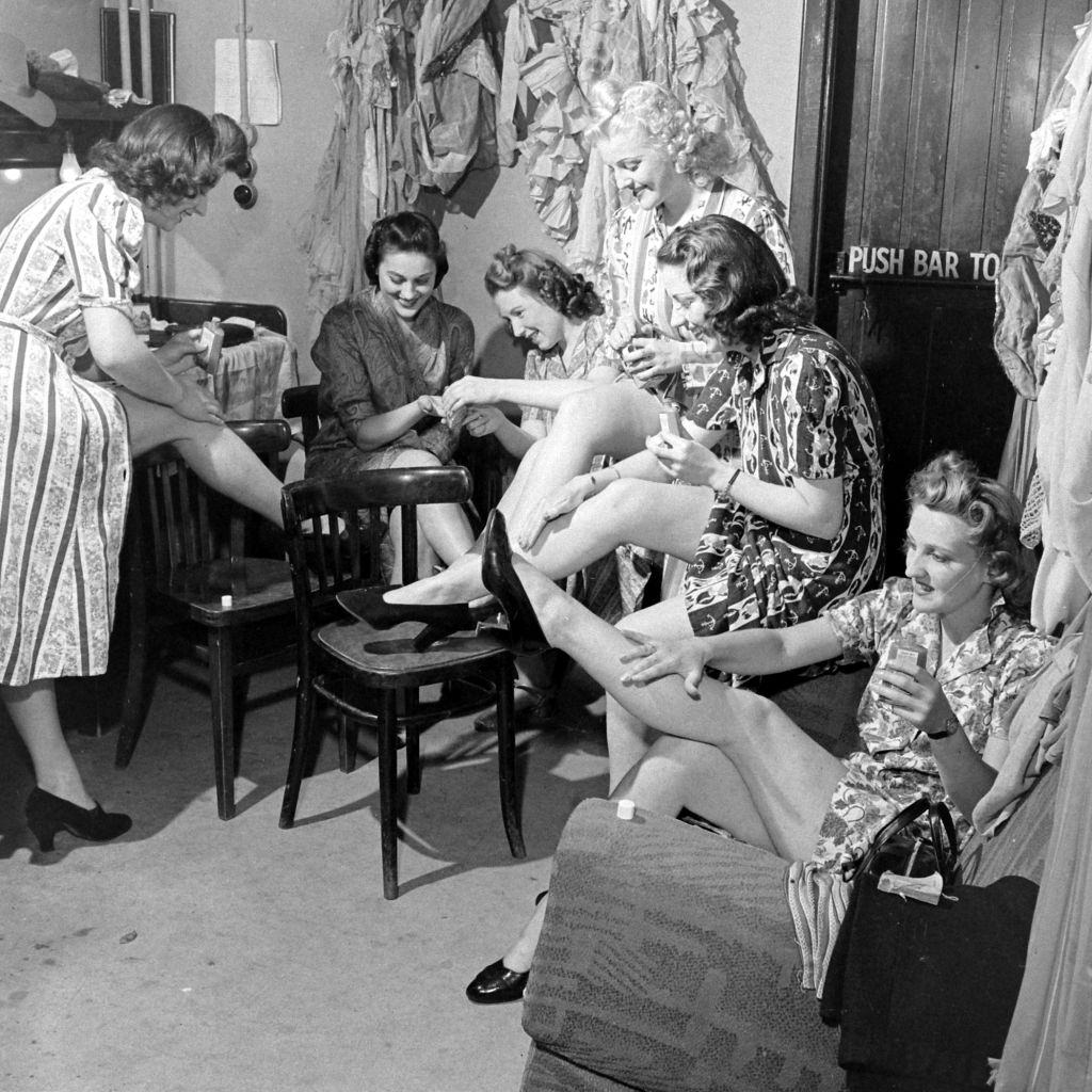 #7 Women applying liquid stockings during World War II, 1941