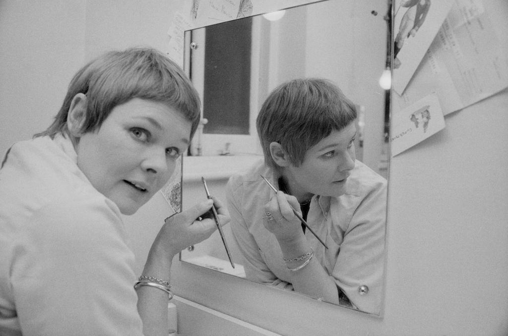 #6 Judi Dench doing her makeup in front of a mirror, 1975.