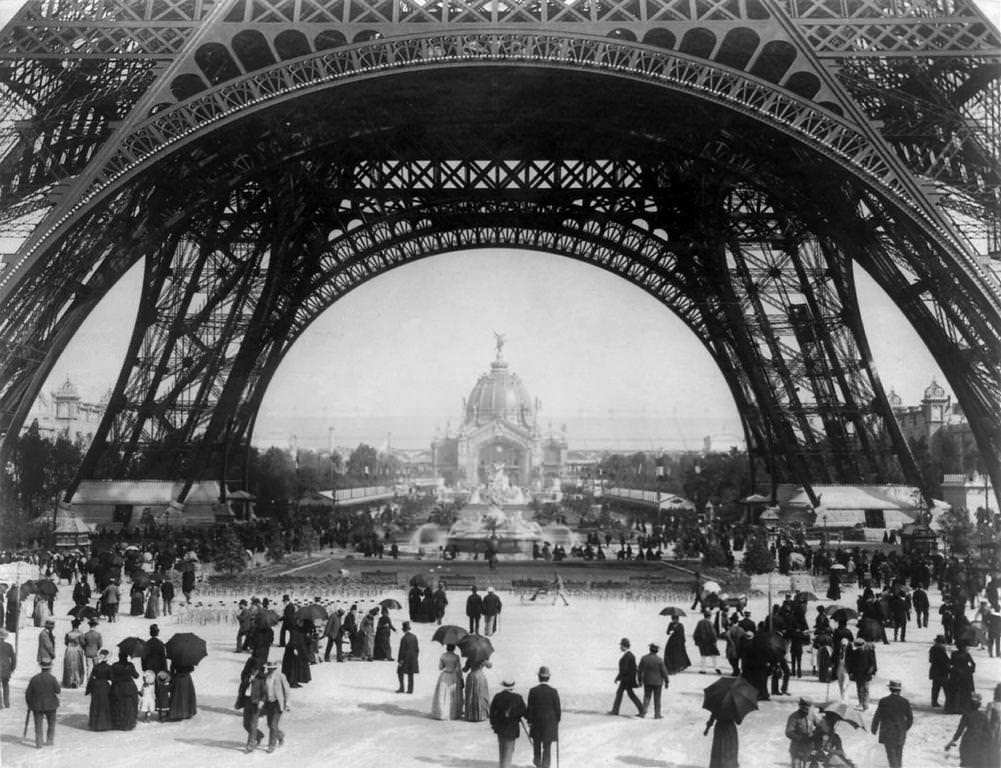 #8 Paris Exposition, view from ground level of the Eiffel tower with Parisians promenading, 1889.