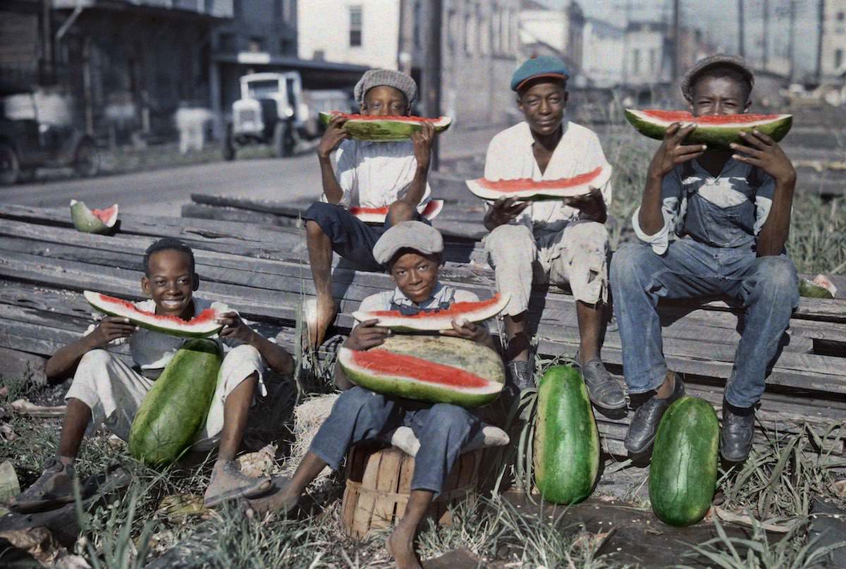 #25 Five boys eat watermelon in New Orlean.