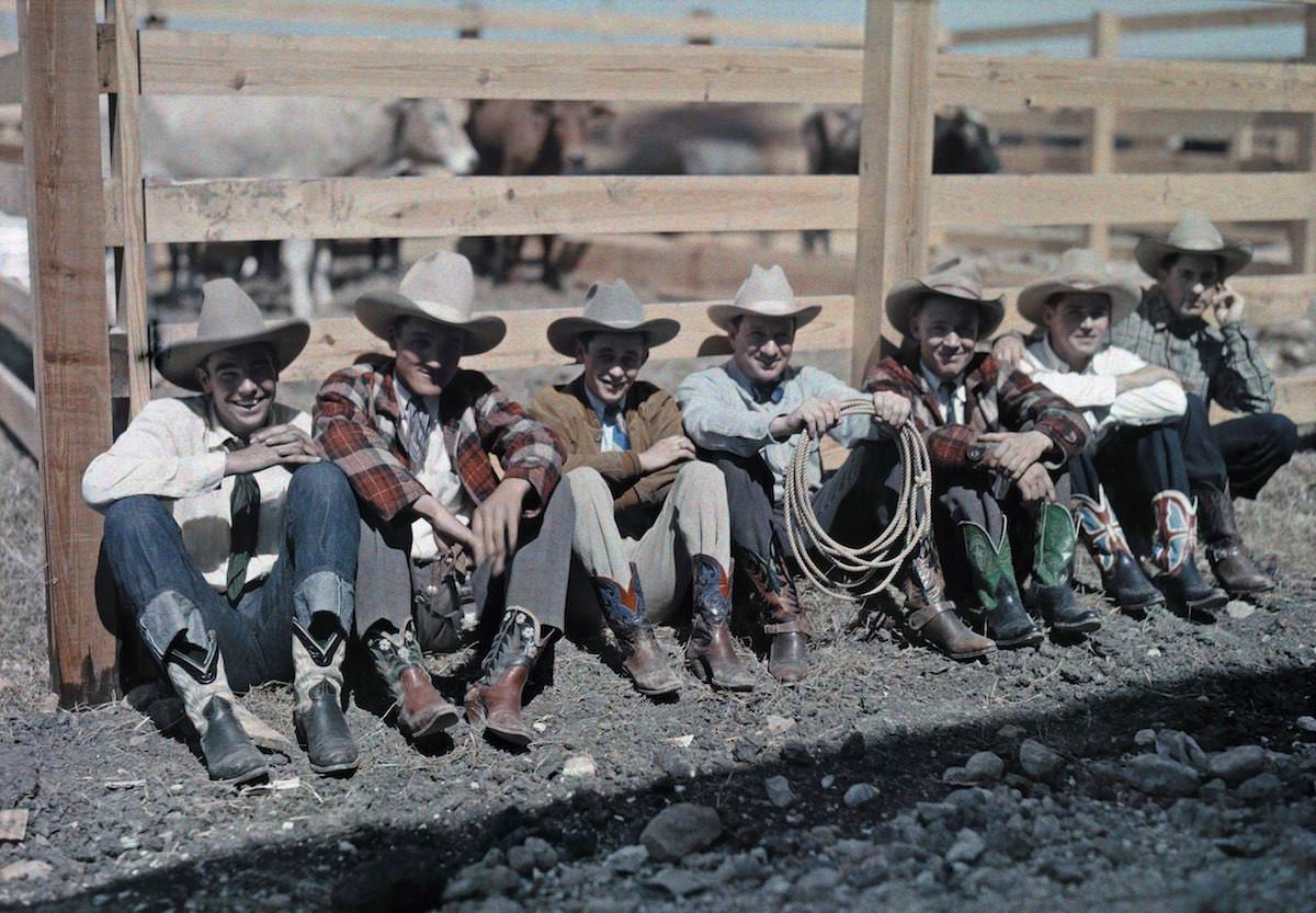 #44 Cowboys and horseback riders sit along a fence at a rodeo, San Antonio, Texas.