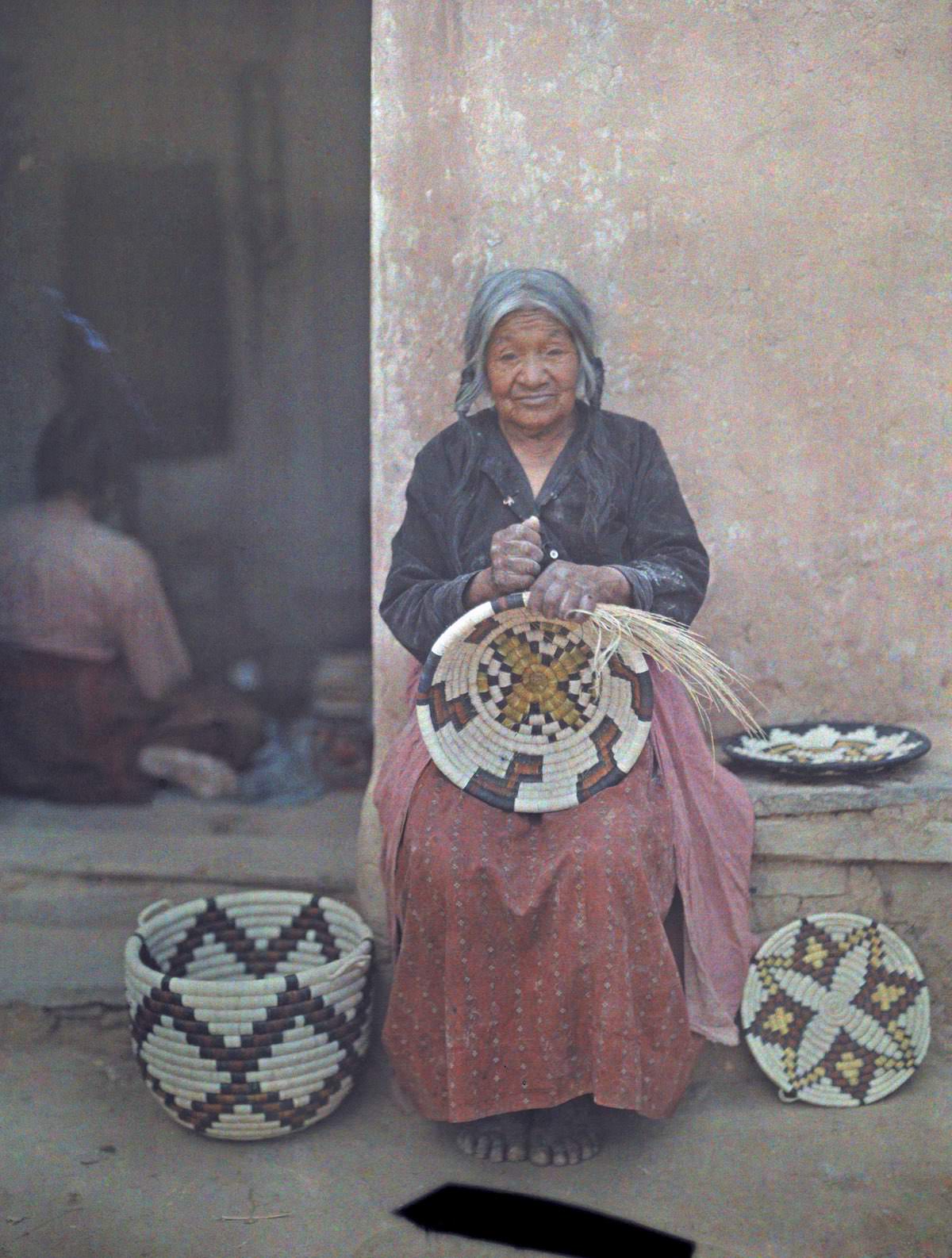 #13 Portrait of a Hopi Indian woman weaving a basket.