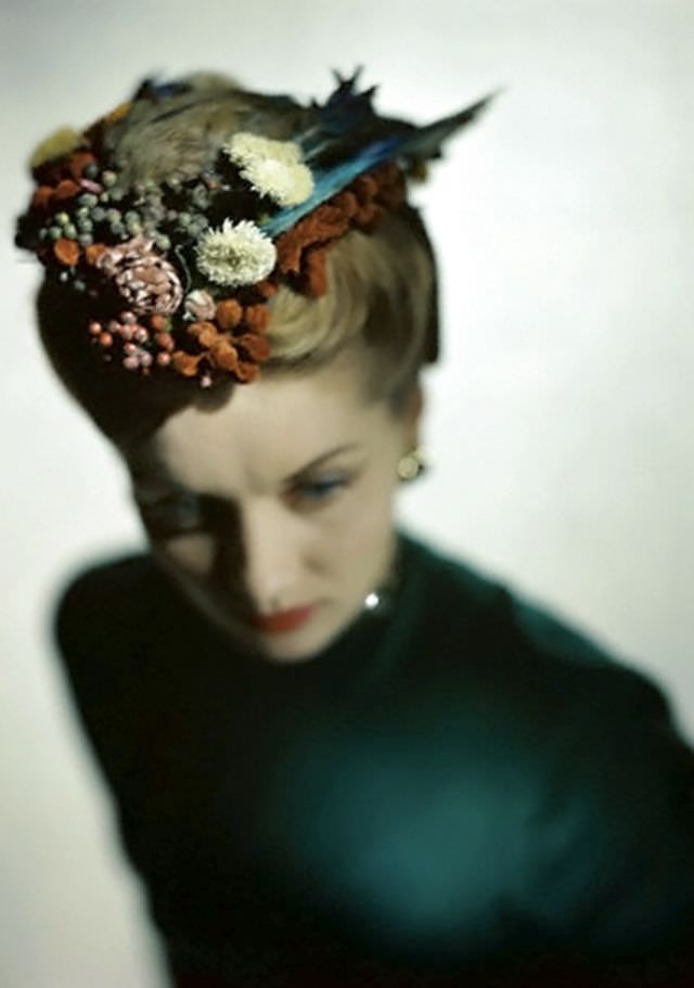 #13 Model wearing Lilly Daché’s bonnet-coif of flowers, feathers, and fruit, 1946