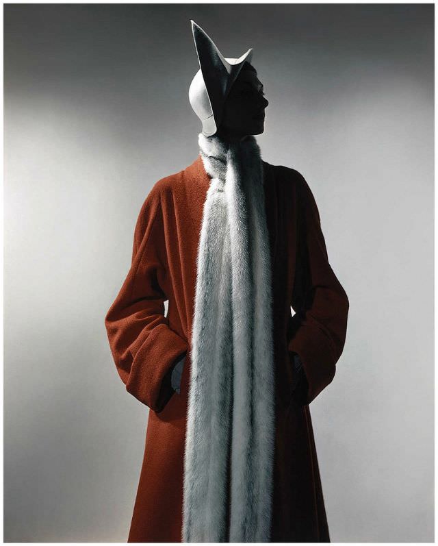 #17 Model is wearing a free-flowing coat made of red French wool and a cream side peak cloché.