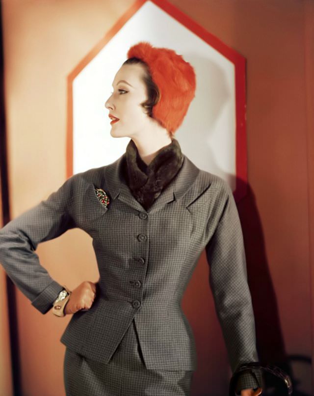#20 Mary Jane Russell in wool checked suit by Adele Simpson, orange fur cap, 1951