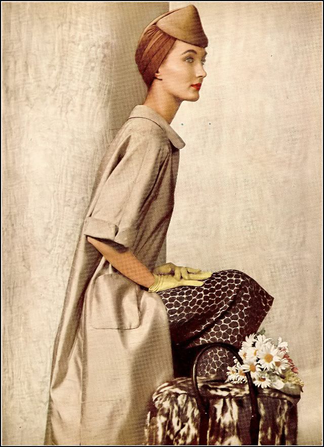 #26 Evelyn Tripp wearing a raw silk coat lined in the same silk surah print of the dress by Adele Simpson, toque, fur carryall from Lord & Taylor, Harper’s Bazaar, 1954