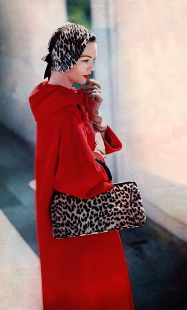#29 Model wearing a coat by Dan Millstein, hat by Lilly Daché, October 1957